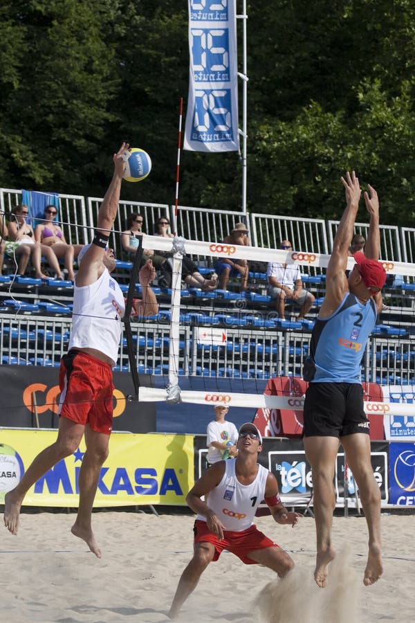 2009 FIVB CEV Lausanne Beach Volley Satellite Tournament - Laciga-Bellaguarda vs Tichy-Dumek. 3-time European Champion Martin Laciga spikes the ball, with his teammate Jason Bellaguarda observing and opponent Martin Tichy trying to block him. 2009 FIVB CEV Lausanne Beach Volley Satellite Tournament - Laciga-Bellaguarda vs Tichy-Dumek. 3-time European Champion Martin Laciga spikes the ball, with his teammate Jason Bellaguarda observing and opponent Martin Tichy trying to block him.