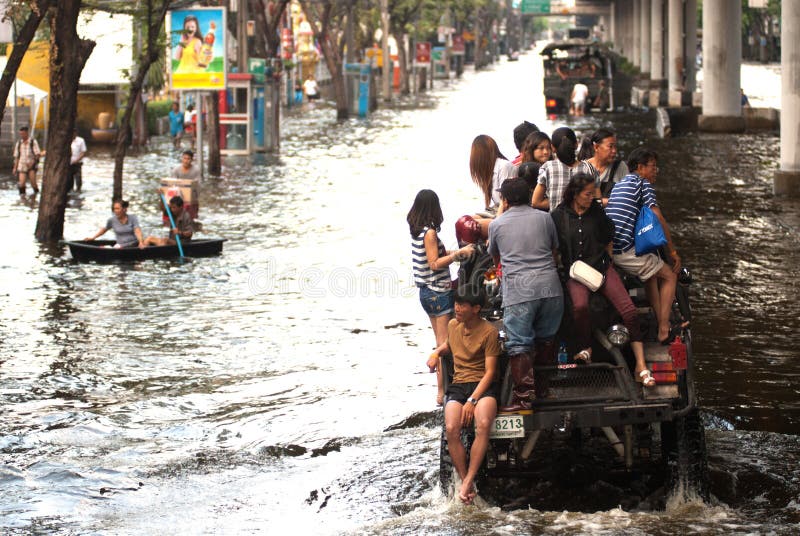 BANGKOK, THAILAND-NOVEMBER 11: Transportation of people in the streets flooded after the heaviest monsoon rain in 70 years in the capital on November 11, 2011 Phahon Yothin Road, bangkok, Thailand. BANGKOK, THAILAND-NOVEMBER 11: Transportation of people in the streets flooded after the heaviest monsoon rain in 70 years in the capital on November 11, 2011 Phahon Yothin Road, bangkok, Thailand.