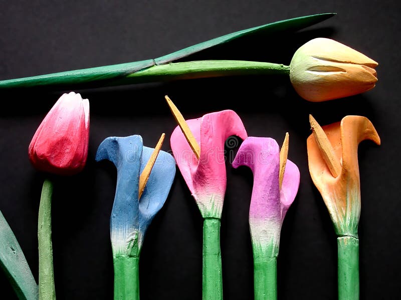 Some wooden colored tulips on a black background. Some wooden colored tulips on a black background