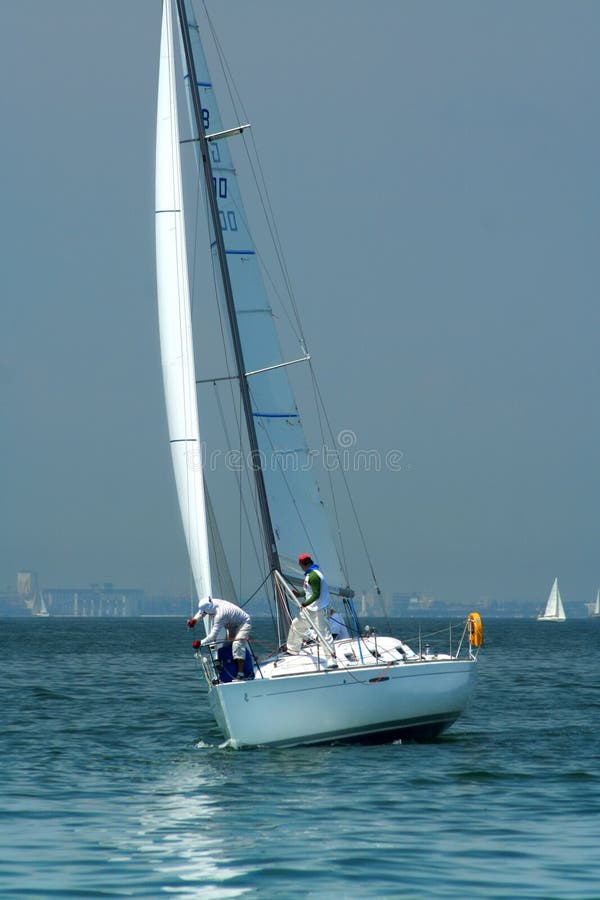 Work of crew of a yacht on sports competitions. Manoeuvering and work with sails. Work of crew of a yacht on sports competitions. Manoeuvering and work with sails.