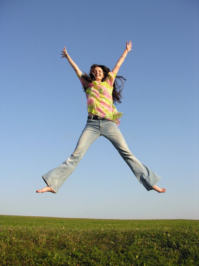 Jump girl with hair on sky and grass. Jump girl with hair on sky and grass