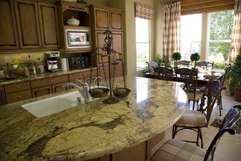 Kitchen with island and wood cabinetry. Kitchen with island and wood cabinetry