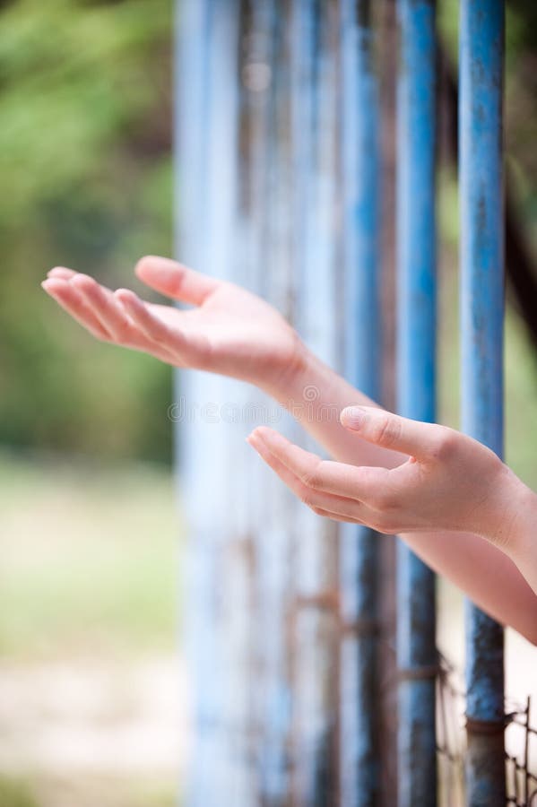 An image of a refugee behind bars. An image of a refugee behind bars