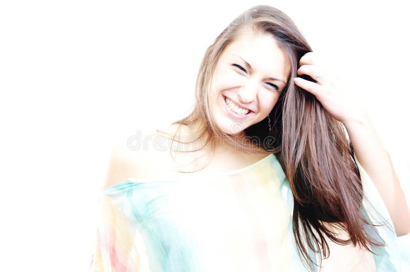 Beautiful brunette laughing while arranging her hair. Beautiful brunette laughing while arranging her hair