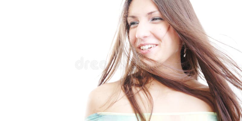 Beautiful brunette with wind blowing through her hair, laughing. Beautiful brunette with wind blowing through her hair, laughing