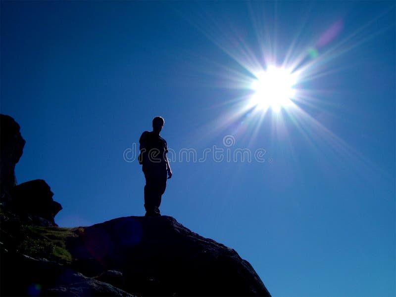 A 'landscape' version of 'The Peak'. A rock / mountain climber at the summit of his climb, basking in brilliant sunshine. The climber is in silhouette, with minor highlights on the body which are created by the brilliant sunshine. A 'landscape' version of 'The Peak'. A rock / mountain climber at the summit of his climb, basking in brilliant sunshine. The climber is in silhouette, with minor highlights on the body which are created by the brilliant sunshine.