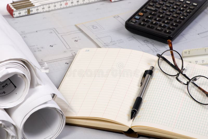 Engineering drawings and tools laid across a table. Engineering drawings and tools laid across a table