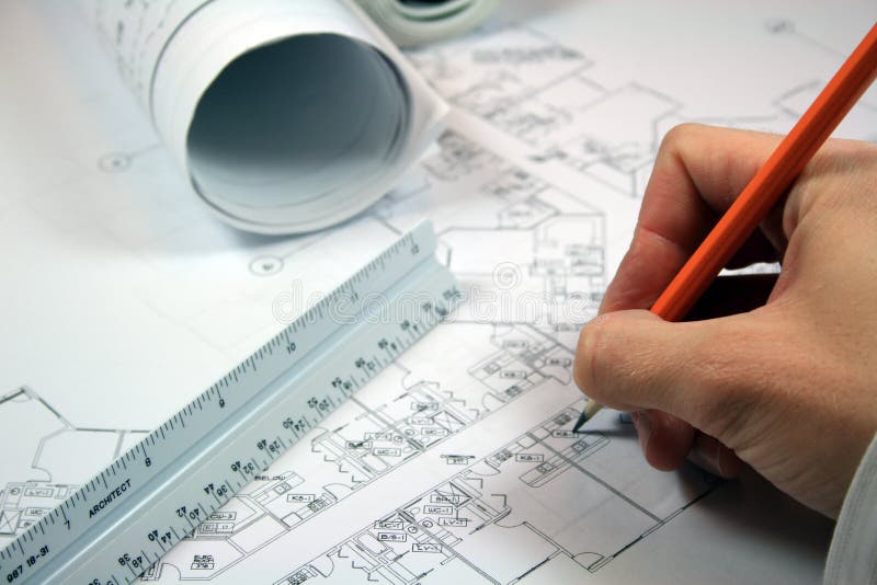 Architect working with blueprints. Closeup with intentional focus on pencil and architect ruler. Architect working with blueprints. Closeup with intentional focus on pencil and architect ruler.