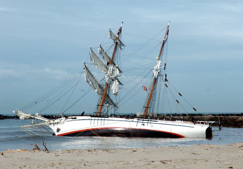 Grounded tallship on sandbar. Grounded tallship on sandbar