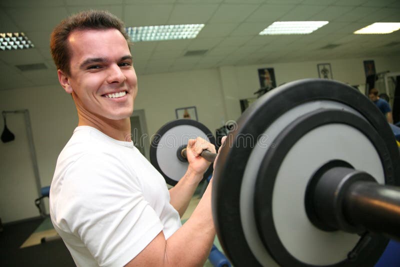 Body builder on physical training in fitness center. Body builder on physical training in fitness center