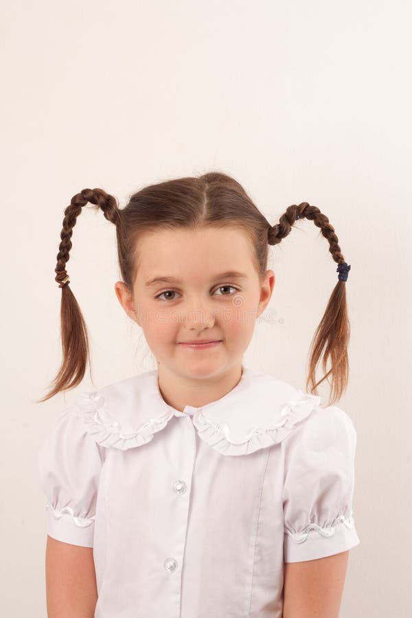 School girl with funny hair style smiling at the camera. School girl with funny hair style smiling at the camera