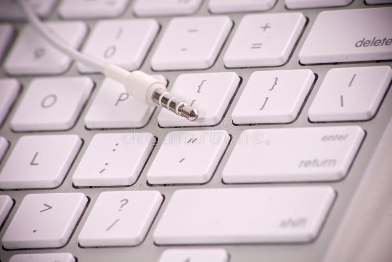 3.5mm Male Plug on Keyboard With Shallow DOF. 3.5mm Male Plug on Keyboard With Shallow DOF