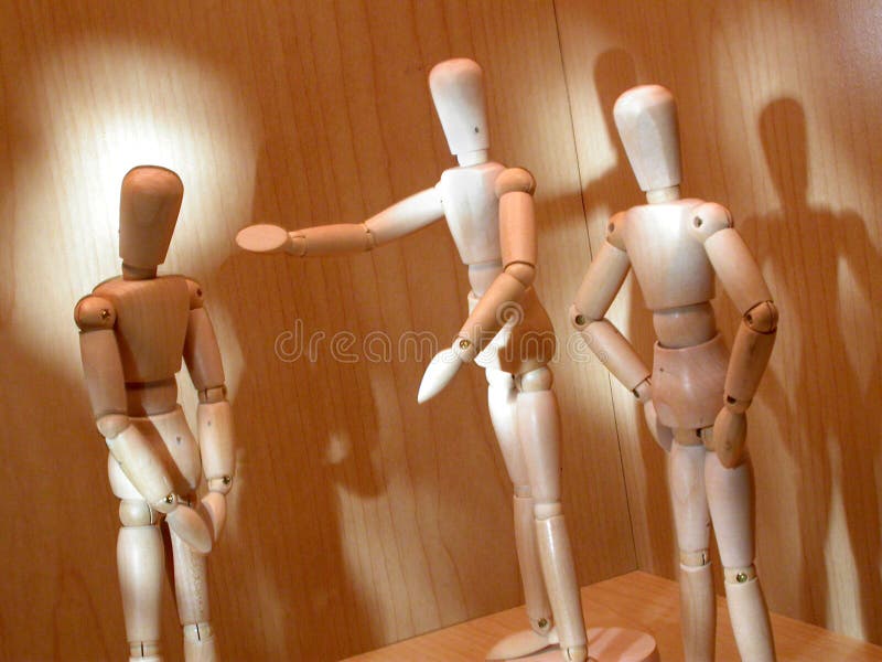 Two mannequins confront a down cast mannequin. Two mannequins confront a down cast mannequin.