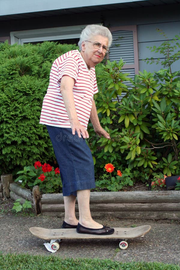 Senior citizen woman with one foot on a skateboard. Senior citizen woman with one foot on a skateboard.