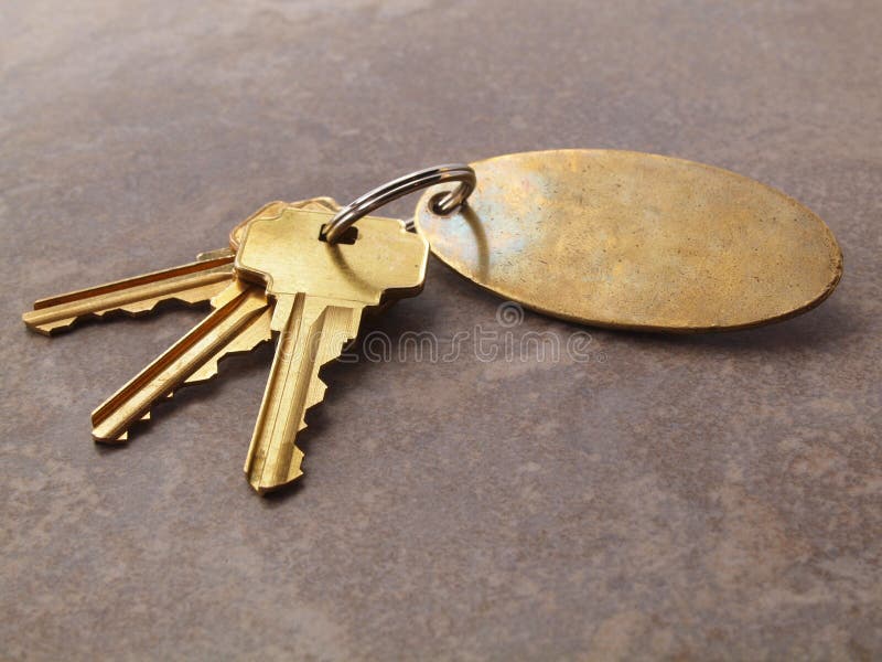 3 Keys and keychain on tile