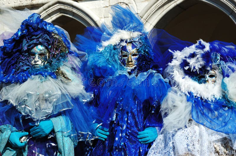 Three masks dressed in blue costumes at St. Mark's Square during the Carnival of Venice on March 28, 2011.The annual carnival was held in 2011 from February 26th to March 8th. Three masks dressed in blue costumes at St. Mark's Square during the Carnival of Venice on March 28, 2011.The annual carnival was held in 2011 from February 26th to March 8th