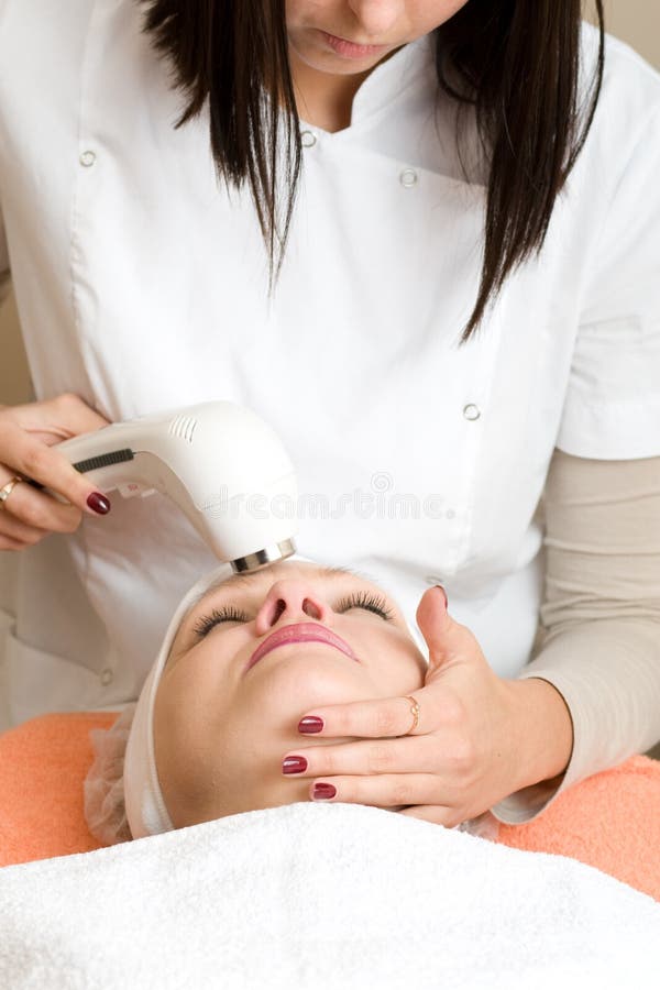 Ultrasonic Skin Scrubber Peeling. Two young women in cosmetic cabinet. Ultrasonic Skin Scrubber Peeling. Two young women in cosmetic cabinet