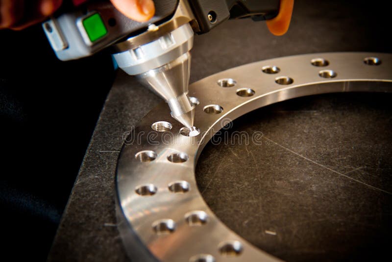 Detail of the tip of a 3d laser scanner mechanical arm, with laser beam scanning a surface. Shallow depth of field, focus on the tipl. Detail of the tip of a 3d laser scanner mechanical arm, with laser beam scanning a surface. Shallow depth of field, focus on the tipl.