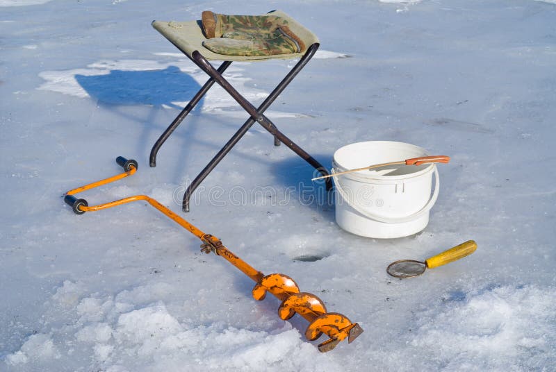 A winter fishing on ice, equipment: auger, camp-chair, ladle, mittens, bucket and rod. A winter fishing on ice, equipment: auger, camp-chair, ladle, mittens, bucket and rod.