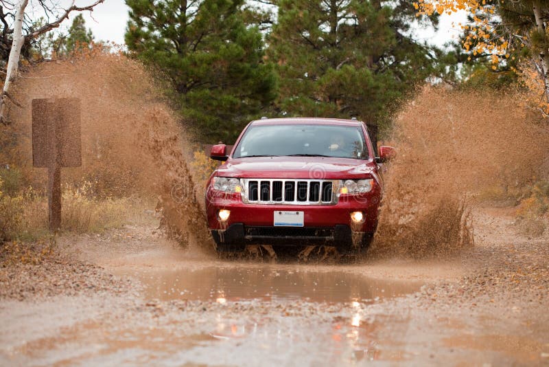 Off road driving jeep through mud with hudge splash. Off road driving jeep through mud with hudge splash