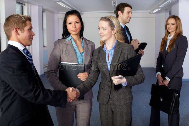 5 young business people, handshake gesture