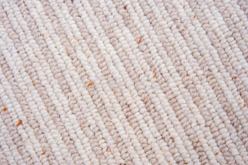 A close up image of a carpet made of 50 % wool and 50% polypropylene with stripes. A close up image of a carpet made of 50 % wool and 50% polypropylene with stripes.