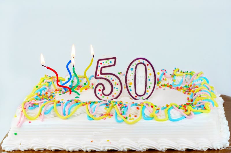 50th Birthday Cake. White frosted birthday cake with lit candles and the number 50 on top stock images 50th Birthday Cake. White frosted birthday cake with lit candles and the number 50 on top stock images
