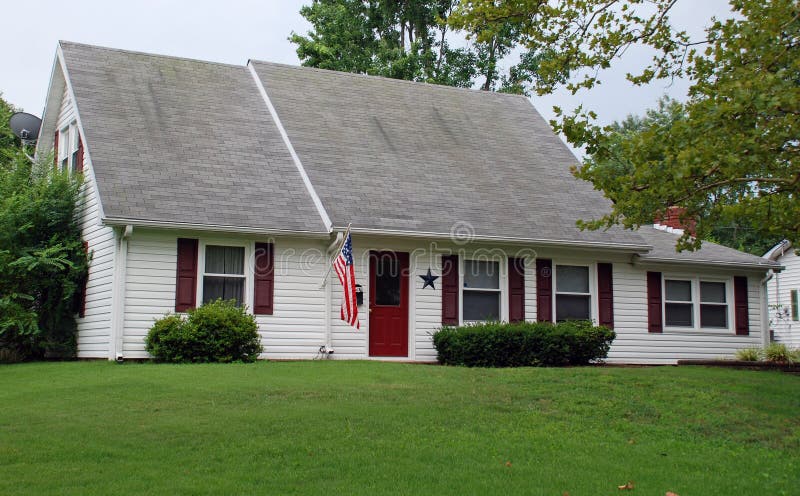 A cute 1 1/2 story home with an american flag. A cute 1 1/2 story home with an american flag.