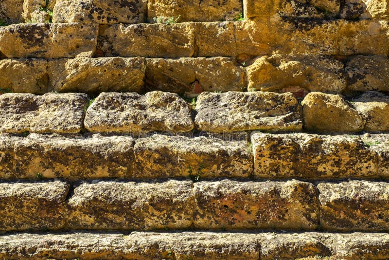 AAncient Greek stone wall closeup texture or background.