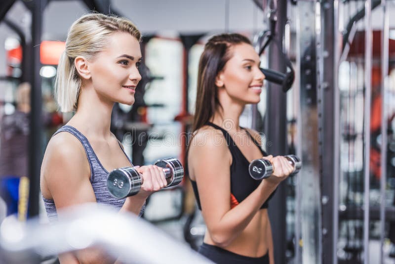 aantrekkelijke atletische vrouwen die met domoren uitwerken stock afbeelding aantrekkelijke atletische vrouwen die met domoren uitwerken stock afbeelding