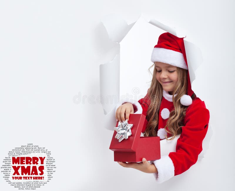 Little girl opening christmas present - with lots of copy space. Little girl opening christmas present - with lots of copy space