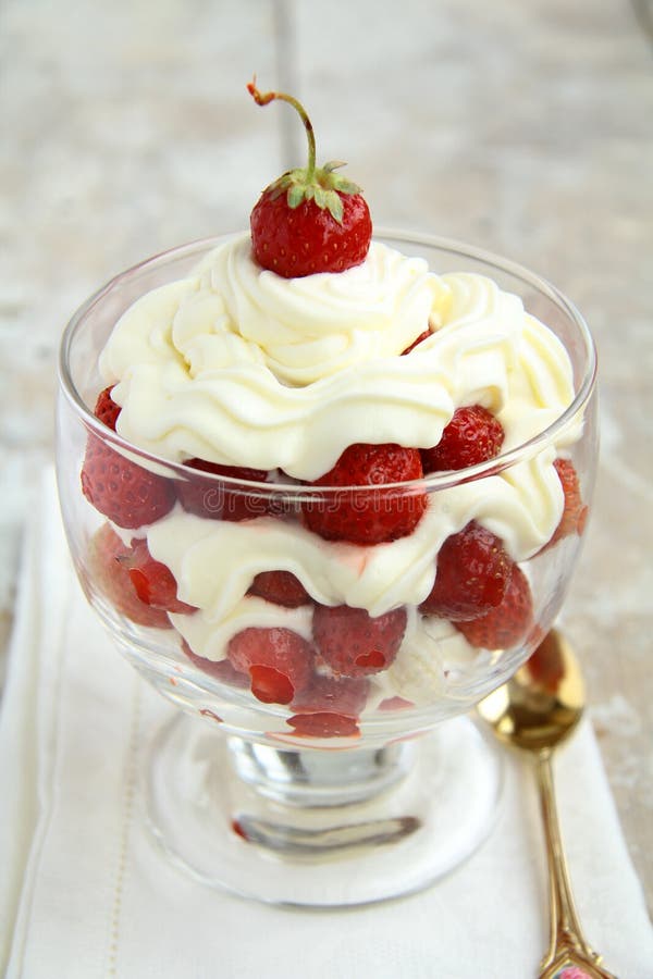 Strawberries with whipped cream in a glass. Strawberries with whipped cream in a glass