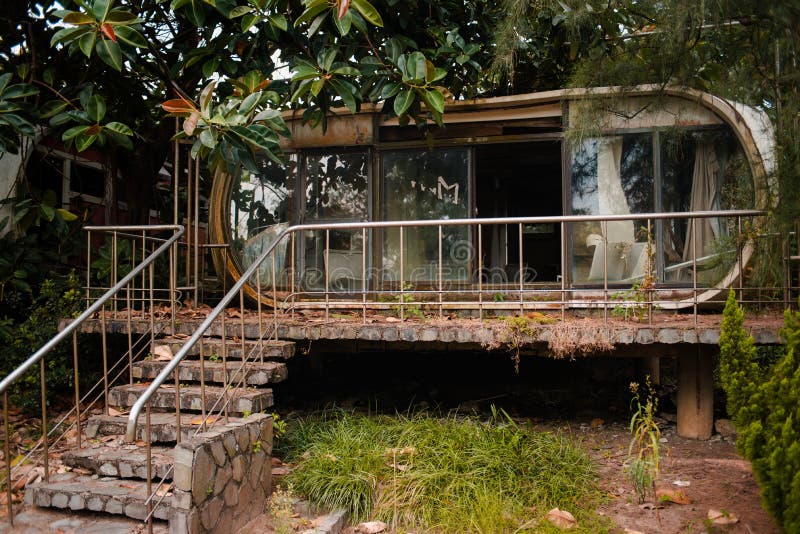 An abandoned ancient building with windows and concrete stairs in Wanli UFO Village, Taiwan