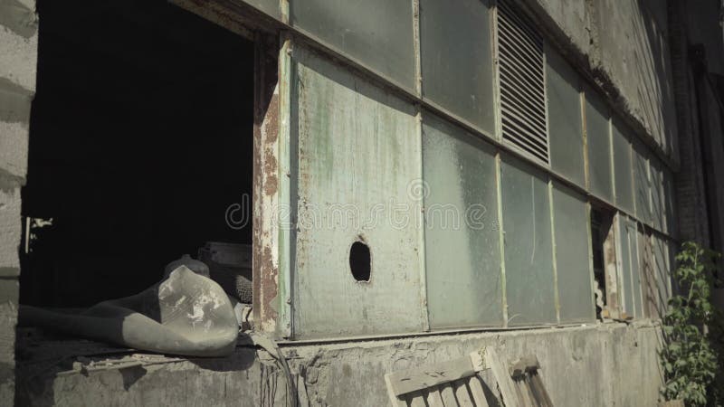 Abandoned building of manufacturing site on sunny day outdoors. Neglected factory construction in desolate area.