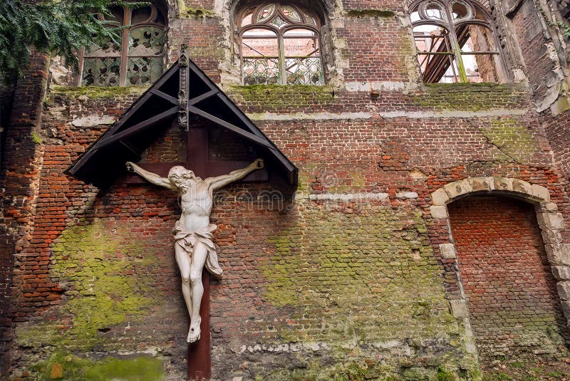 Abandoned church with Jesus figure on rustic brick wall. Old place for worshipers