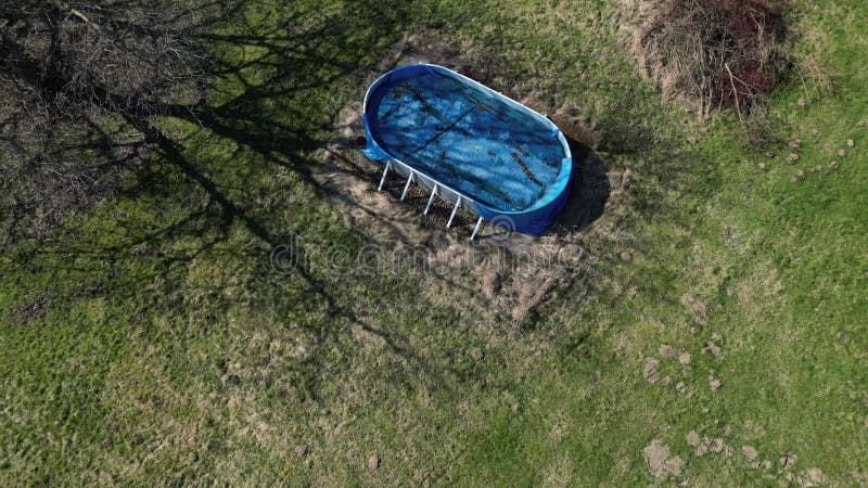 Abandoned garden with a cheap pool shape oval. neglected