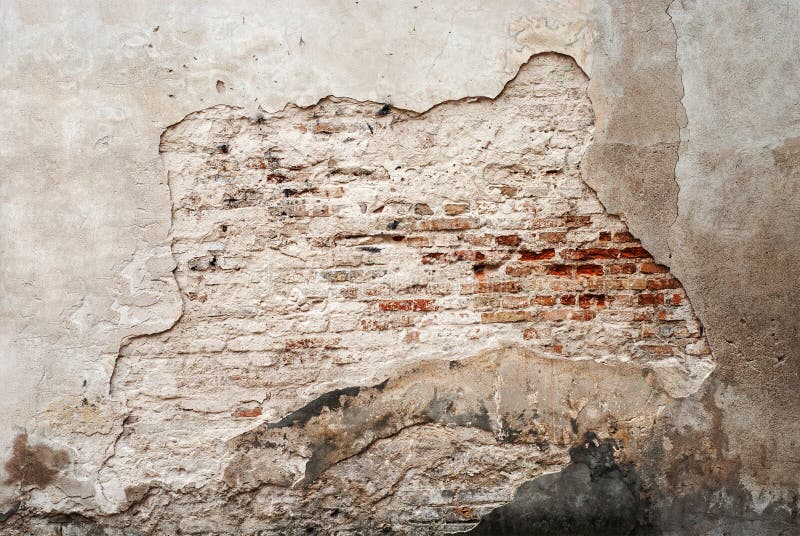 Abandoned grunge cracked brick stucco wall