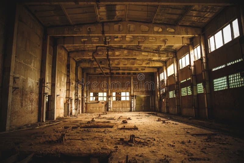 Abandoned industrial creepy warehouse inside old dark grunge factory building