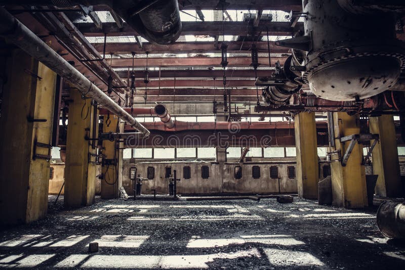 Abandoned metallurgical excavator plant or factory interior, industrial warehouse building waiting for a demolition stock image Abandoned metallurgical excavator plant or factory interior, industrial warehouse building waiting for a demolition stock image