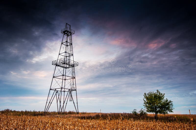 Abandoned oil rig, dramatic clouds and evening sky