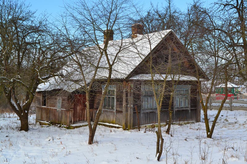 Abandoned old russian wooden house. Timber texture. Home exterior. Winter landscape