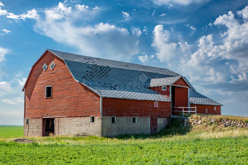 An abandoned red basement or bank barn on the Saskatchewan prairies