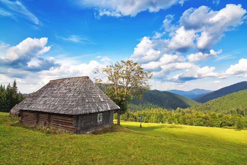 Abandoned wooden house in the mountains and forest.