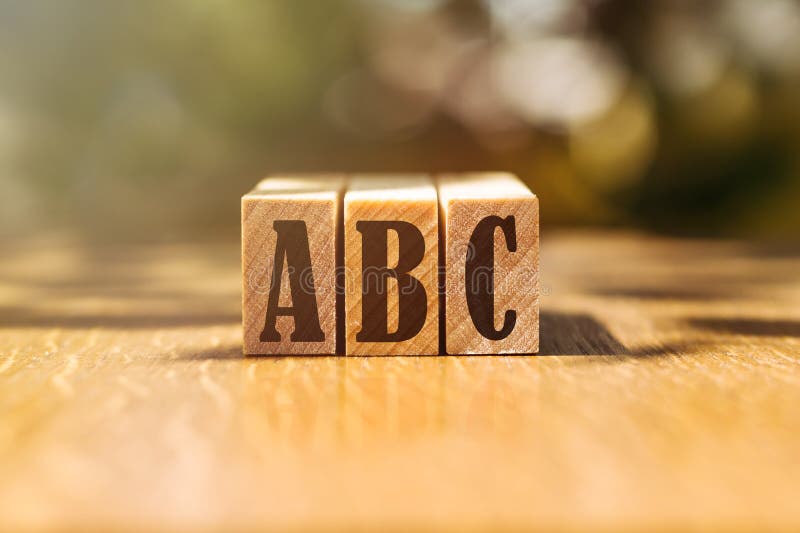ABC Acronym Concept. Text on Wooden Cubes with Bright Light Stock