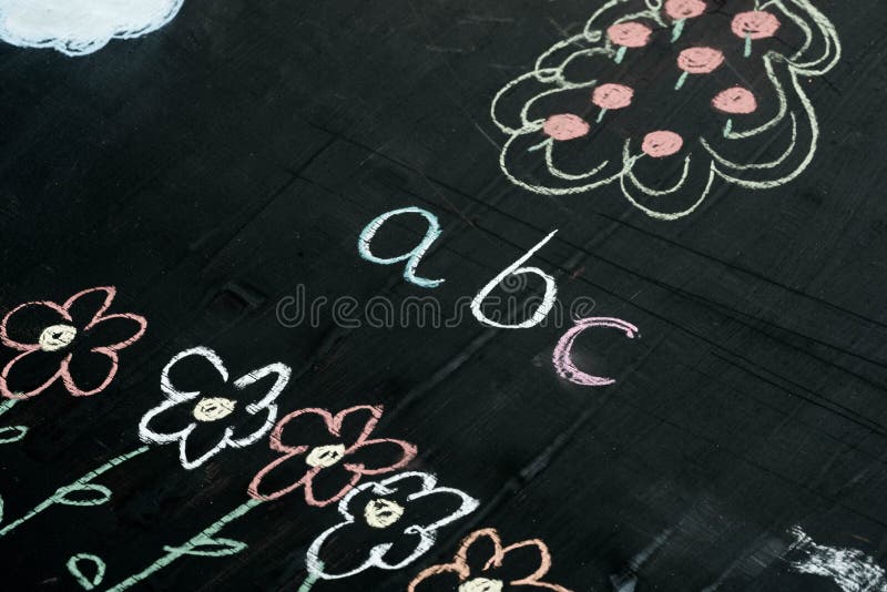 Abc letters chalk drawing on blackboard selective focus macro