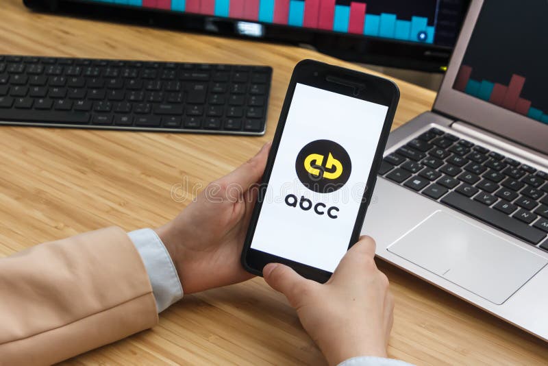 ABCC Cryptocurrency Exchange Market. Female Trader Hands Holding the Smartphone Using Application. Crypto Background royalty free stock photo