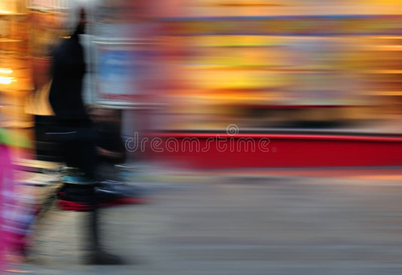 Bright evening city blur with silhouette of woman walking. Bright evening city blur with silhouette of woman walking