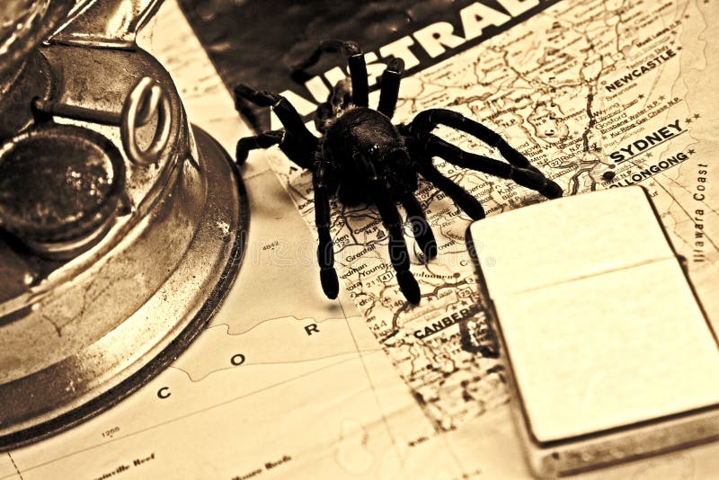 Travel background from a big spider on a Australian map with old lamp and zippo. Travel background from a big spider on a Australian map with old lamp and zippo