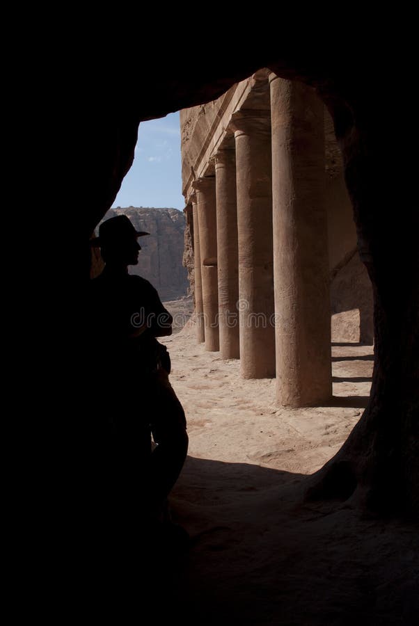 Adventurer (Indiana Jones look) near old columns in mystery ancient nabatean city Petra, Jordan. Good for book cover, postcards or adventure equipment advertising. Adventurer (Indiana Jones look) near old columns in mystery ancient nabatean city Petra, Jordan. Good for book cover, postcards or adventure equipment advertising.