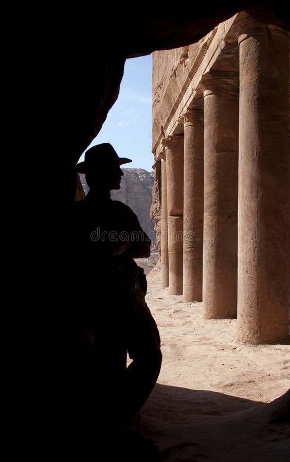 Adventurer (Indiana Jones look) near old columns in mystery ancient nabatean city Petra, Jordan. Good for book cover, postcards or adventure equipment advertising. Adventurer (Indiana Jones look) near old columns in mystery ancient nabatean city Petra, Jordan. Good for book cover, postcards or adventure equipment advertising.